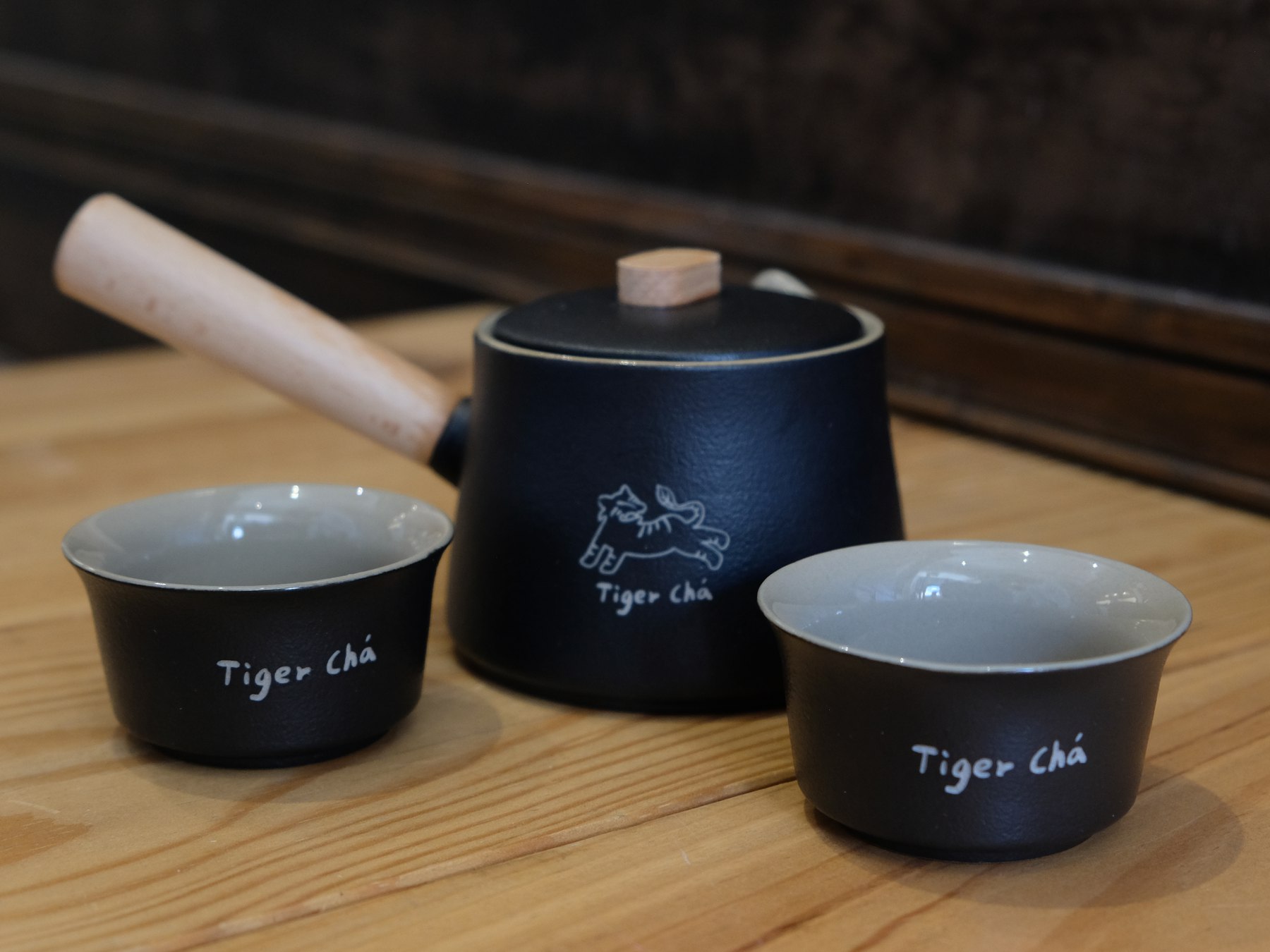 TigerCha teapot product photo with wooden handle and laser tiger crest.